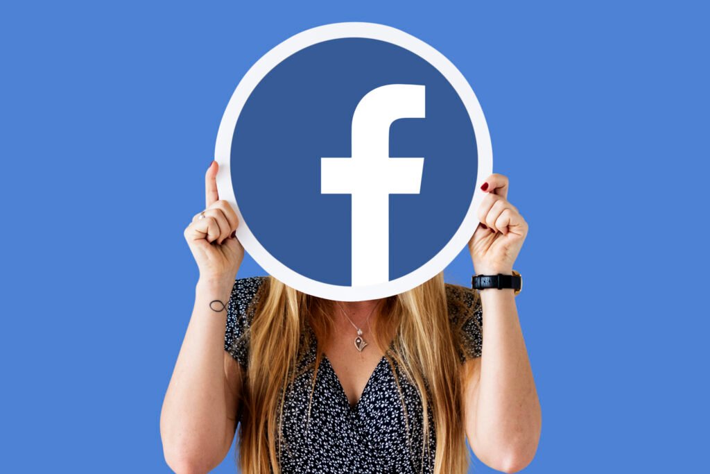 Woman showing a Facebook icon