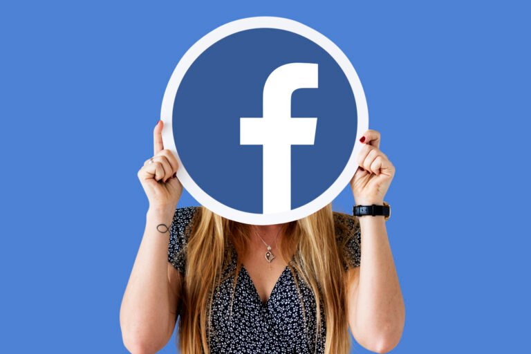 Woman showing a Facebook icon
