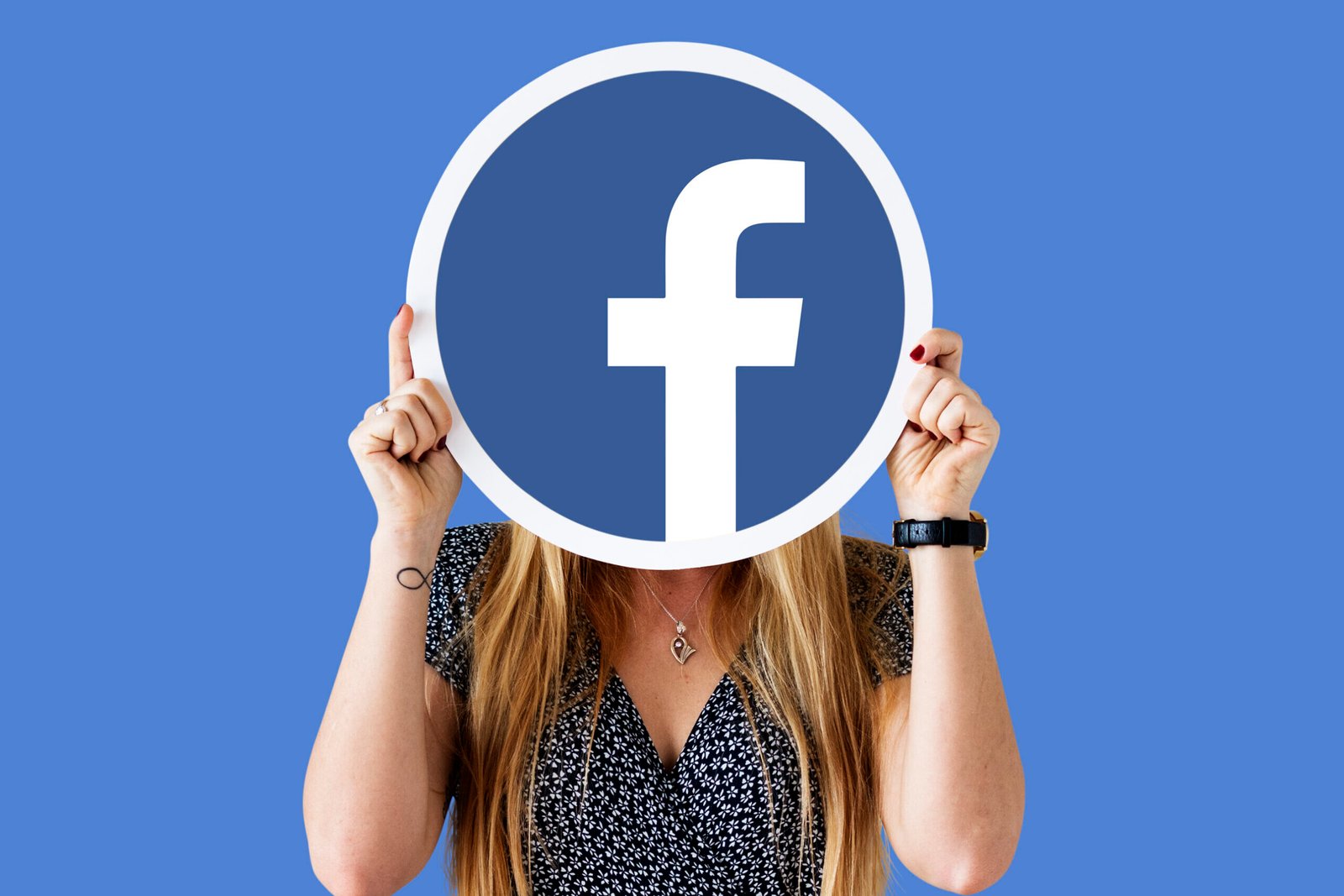 Woman showing a Facebook icon